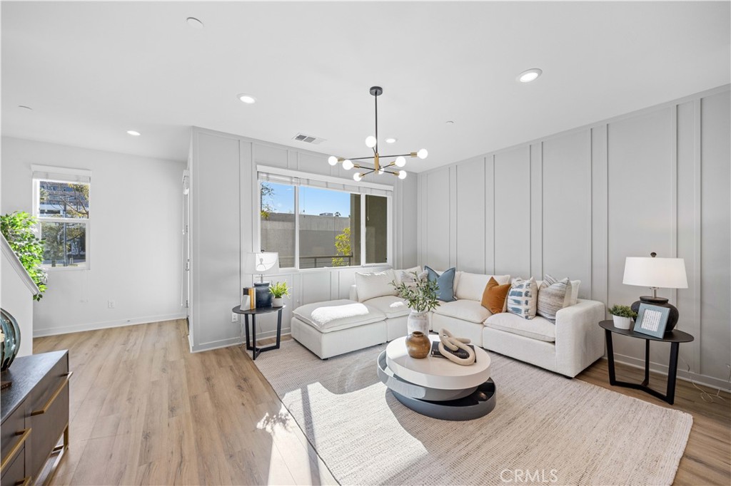108 Citysquare Irvine, CA 92614 - Photo 12 of 45 a living room with furniture and a chandelier