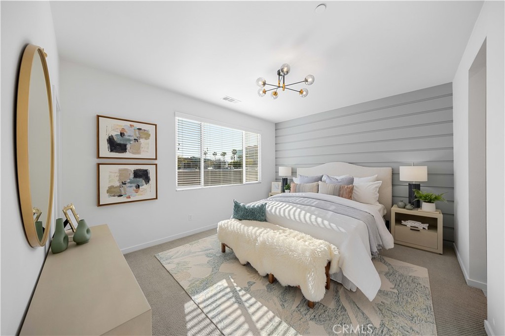 108 Citysquare Irvine, CA 92614 - Photo 21 of 45 a bedroom with bed and a chandelier