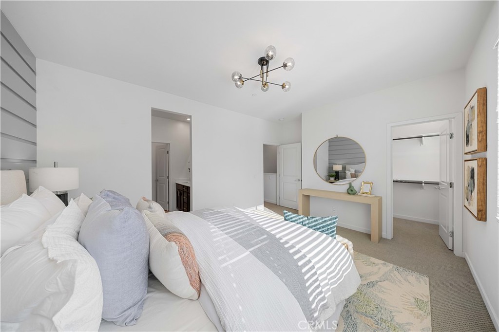 108 Citysquare Irvine, CA 92614 - Photo 23 of 45 a bedroom with a bed and a chandelier