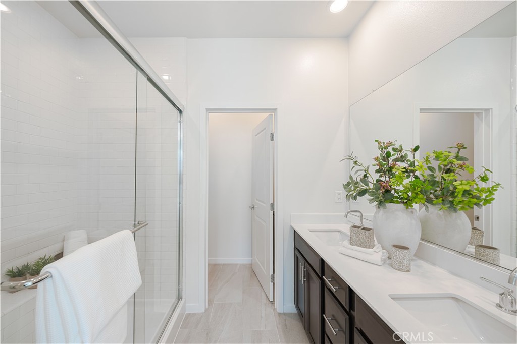 108 Citysquare Irvine, CA 92614 - Photo 24 of 45 a bathroom with a double vanity sink and a mirror