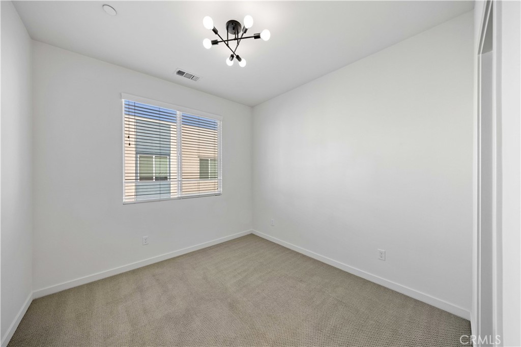 108 Citysquare Irvine, CA 92614 - Photo 27 of 45 a view of a room with a window and a ceiling fan