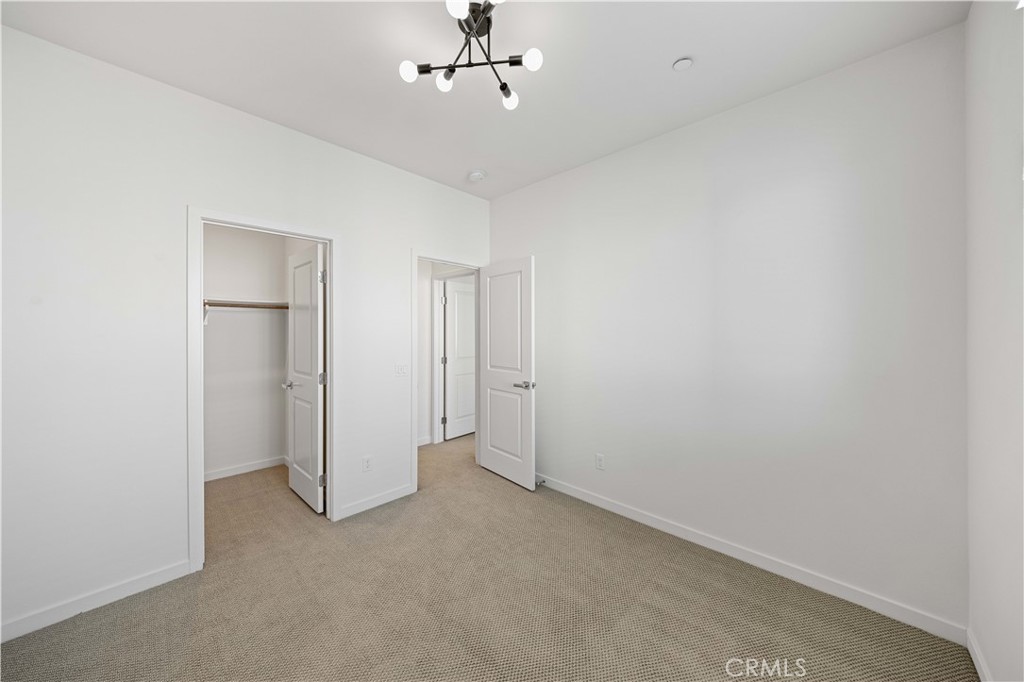 108 Citysquare Irvine, CA 92614 - Photo 28 of 45 an empty room with chandelier fan