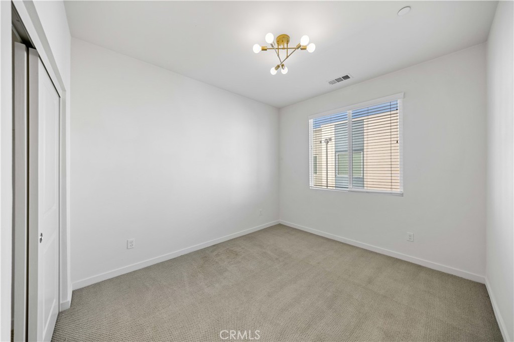 108 Citysquare Irvine, CA 92614 - Photo 29 of 45 an empty room with a window and chandelier fan