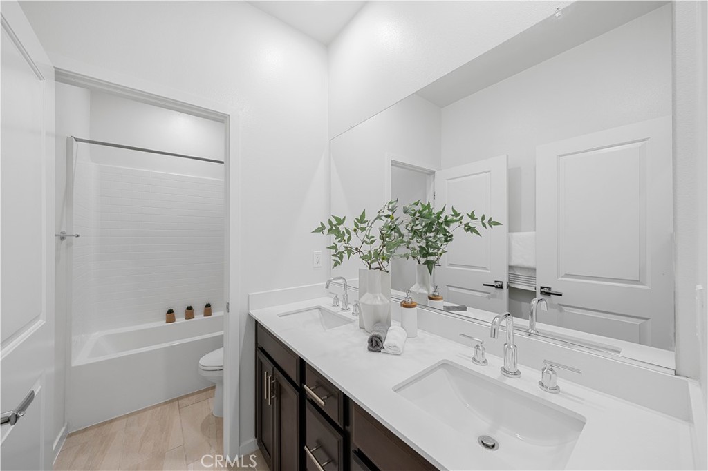 108 Citysquare Irvine, CA 92614 - Photo 31 of 45 a bathroom with a bathtub shower sink and a mirror