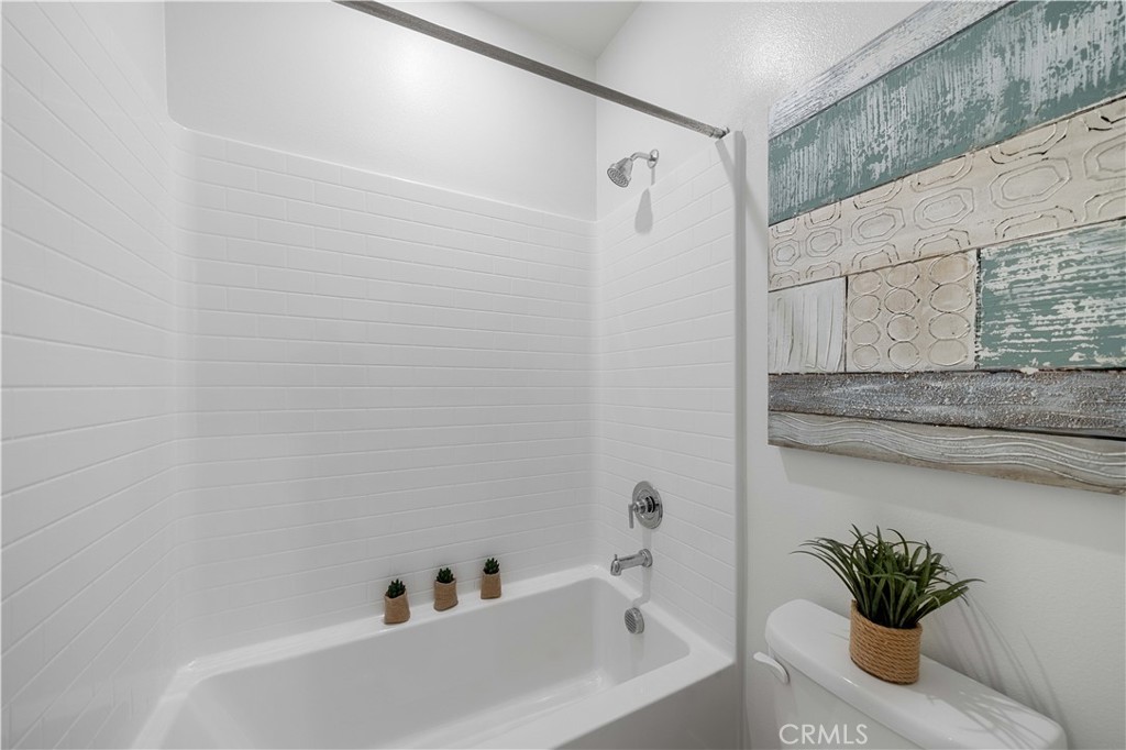 108 Citysquare Irvine, CA 92614 - Photo 32 of 45 a bathroom with a bathtub and a shower