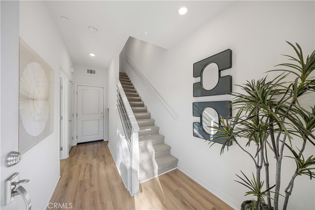 108 Citysquare Irvine, CA 92614 - Photo 7 of 45 a view of entryway with wooden floor