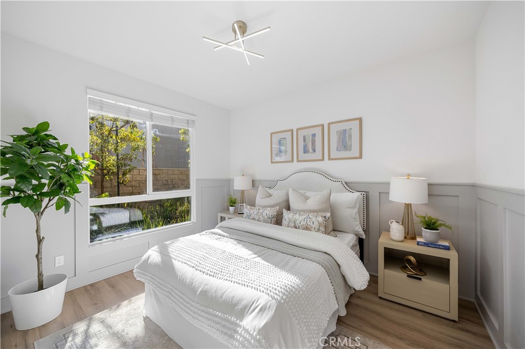 108 Citysquare Irvine, CA 92614 - Photo 8 of 45 a bedroom with bed and a potted plant