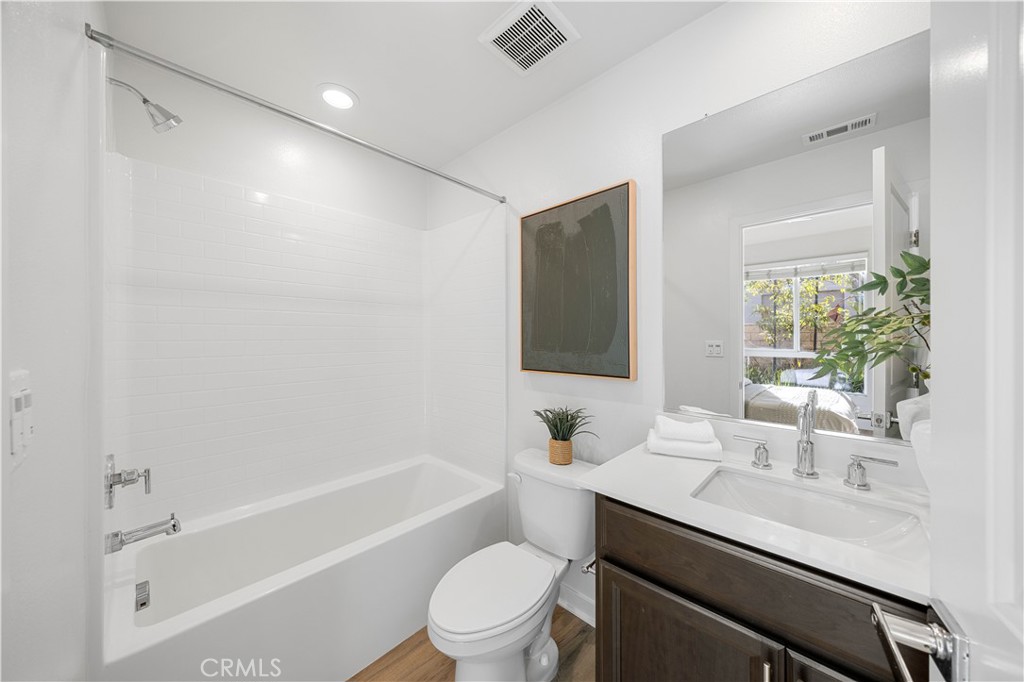 108 Citysquare Irvine, CA 92614 - Photo 10 of 45 a bathroom with a sink a toilet a mirror and shower