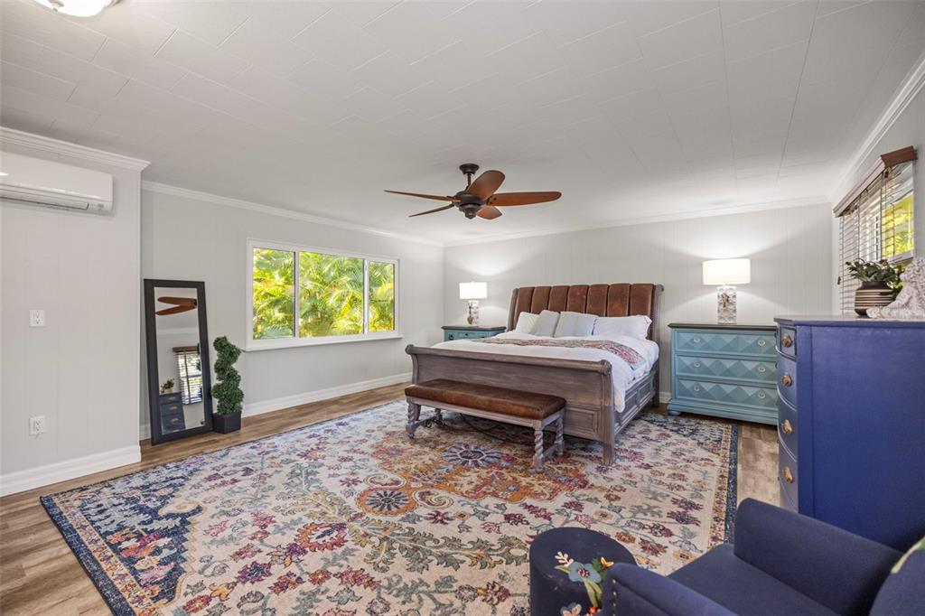 400 Broadway Dunedin, FL 34698 - Photo 29 of 84 a bedroom with a bed and wooden floor