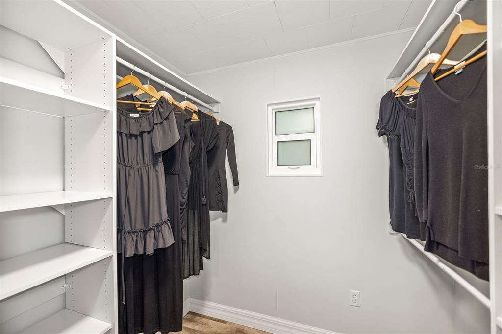 400 Broadway Dunedin, FL 34698 - Photo 35 of 84 a view of walk in closet with clothes and shoes