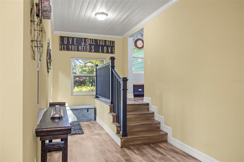 400 Broadway Dunedin, FL 34698 - Photo 53 of 84 a view of a hallway with entryway wooden floor and front door