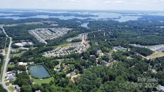 an aerial view of a city with lots of residential buildings and mountain view