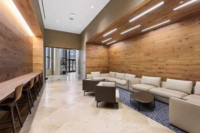 a living room with fireplace furniture and a ceiling fan