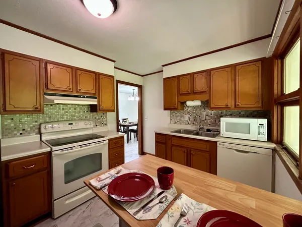 a kitchen with stainless steel appliances granite countertop a stove and a sink