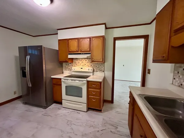 a kitchen with stainless steel appliances a refrigerator and a stove