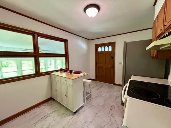 a kitchen with stainless steel appliances granite countertop a stove a sink and dishwasher with wooden cabinets
