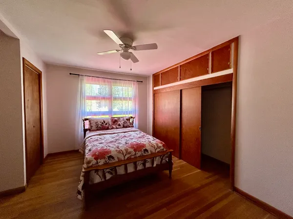 a view of a room with wooden floor and a window