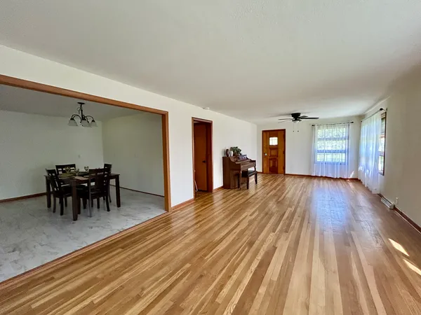 a view of dining room with furniture and wooden floor