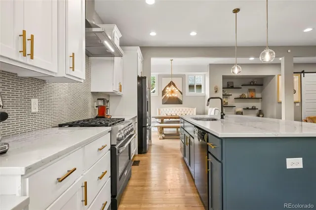 a kitchen with kitchen island a sink stainless steel appliances and cabinets