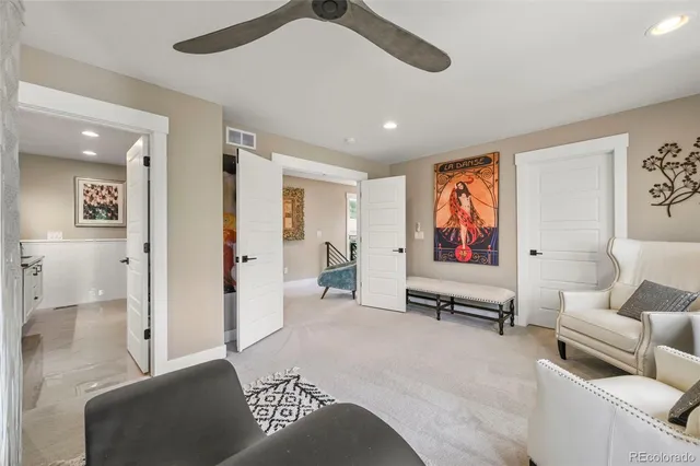 a living room with furniture and a ceiling fan