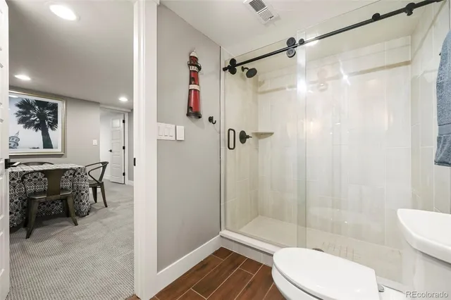 a living room with furniture a fireplace and a ceiling fan