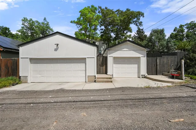 front view of a house with a yard and potted plants