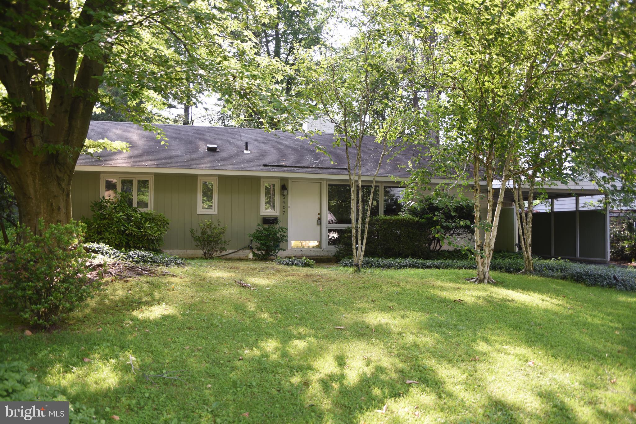 5407 Ferndale Street Springfield, VA 22151 - Photo 1 of 14 a yellow house in middle of the forest
