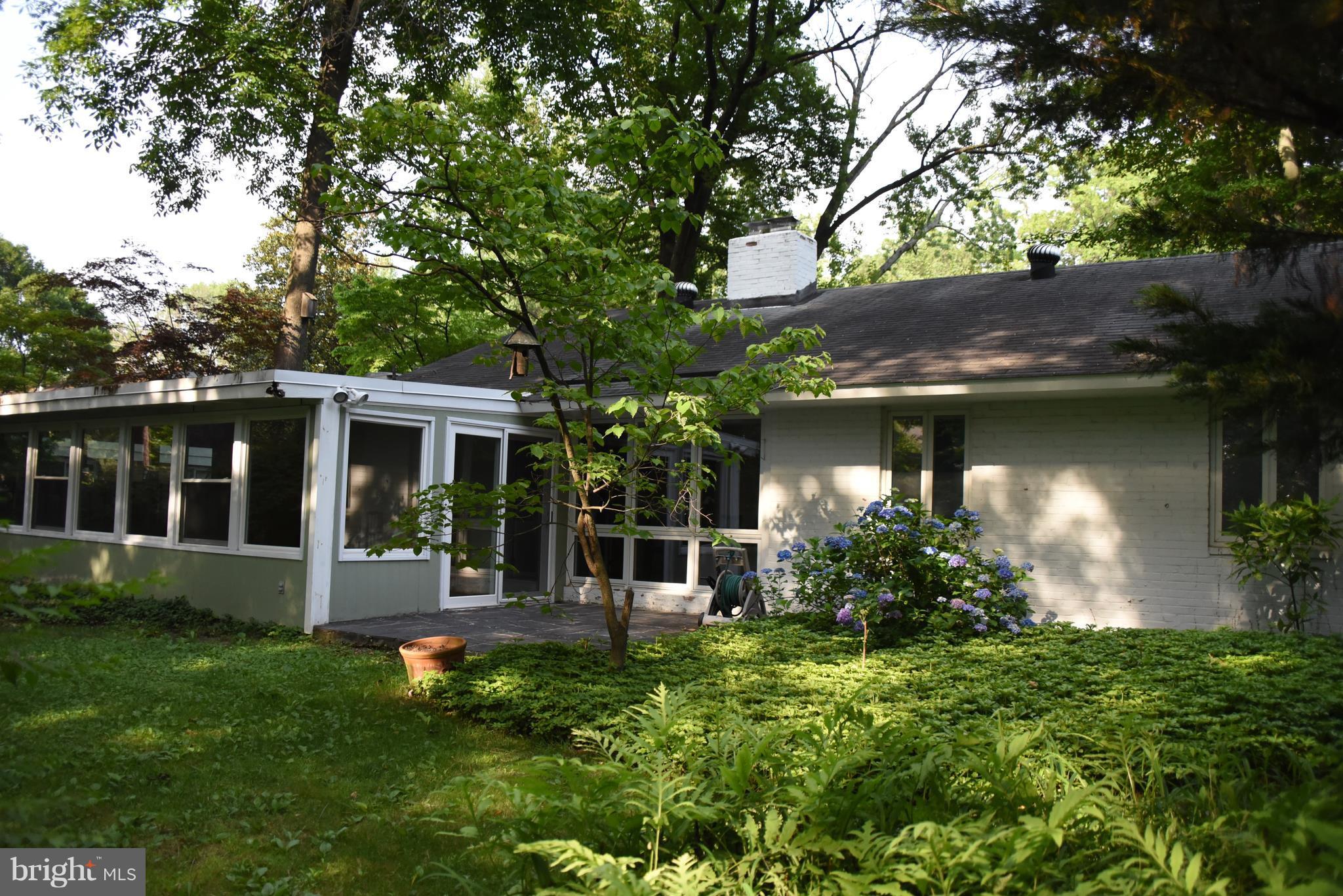 5407 Ferndale Street Springfield, VA 22151 - Photo 13 of 14 a front view of a house with a yard and potted plants