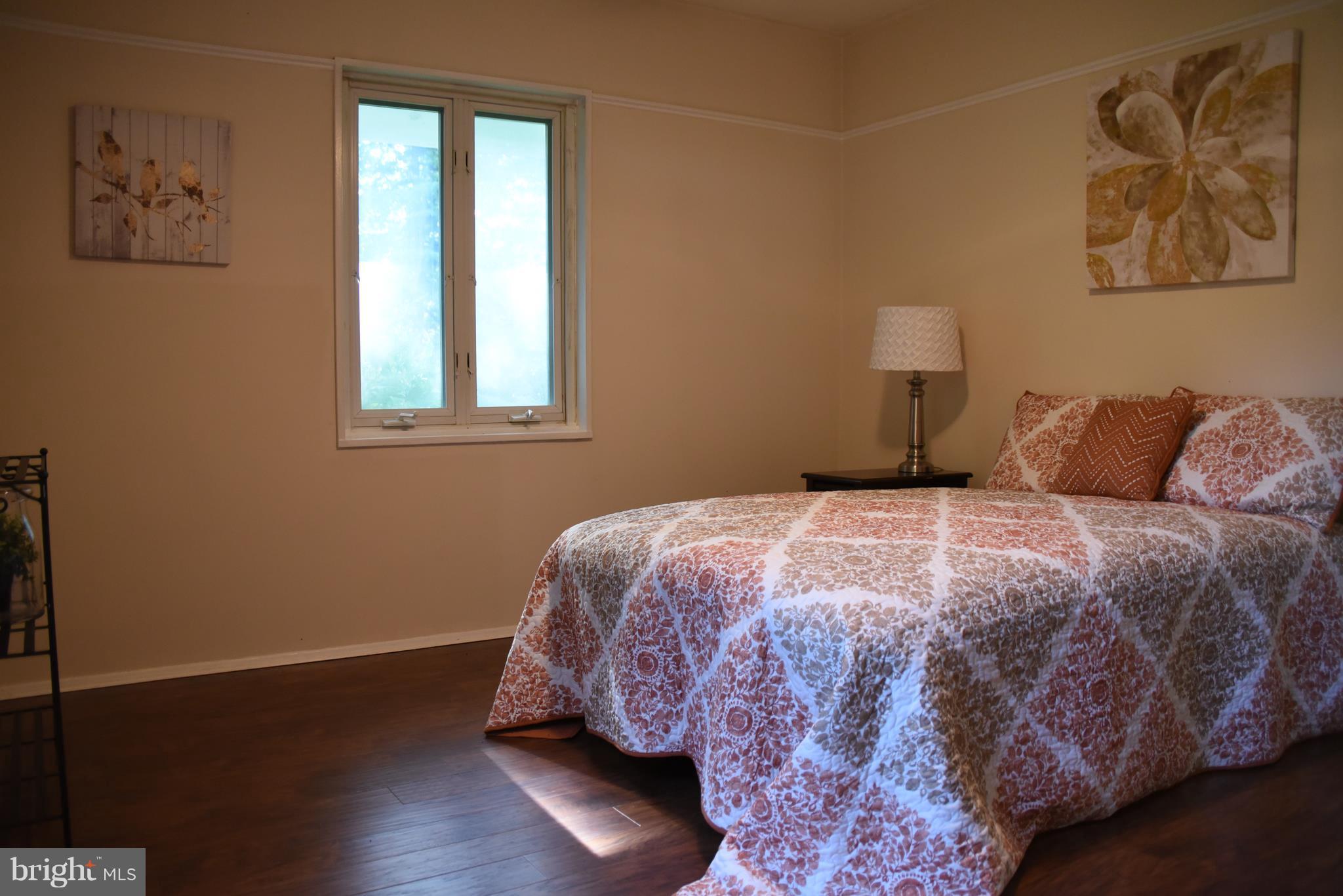 5407 Ferndale Street Springfield, VA 22151 - Photo 8 of 14 a bedroom with a bed and wooden floor