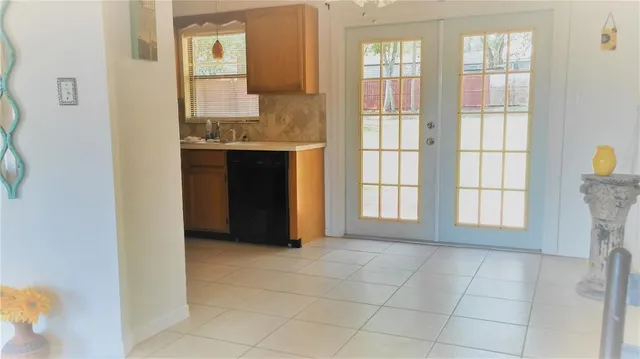 a view of an empty room with a fireplace and a window