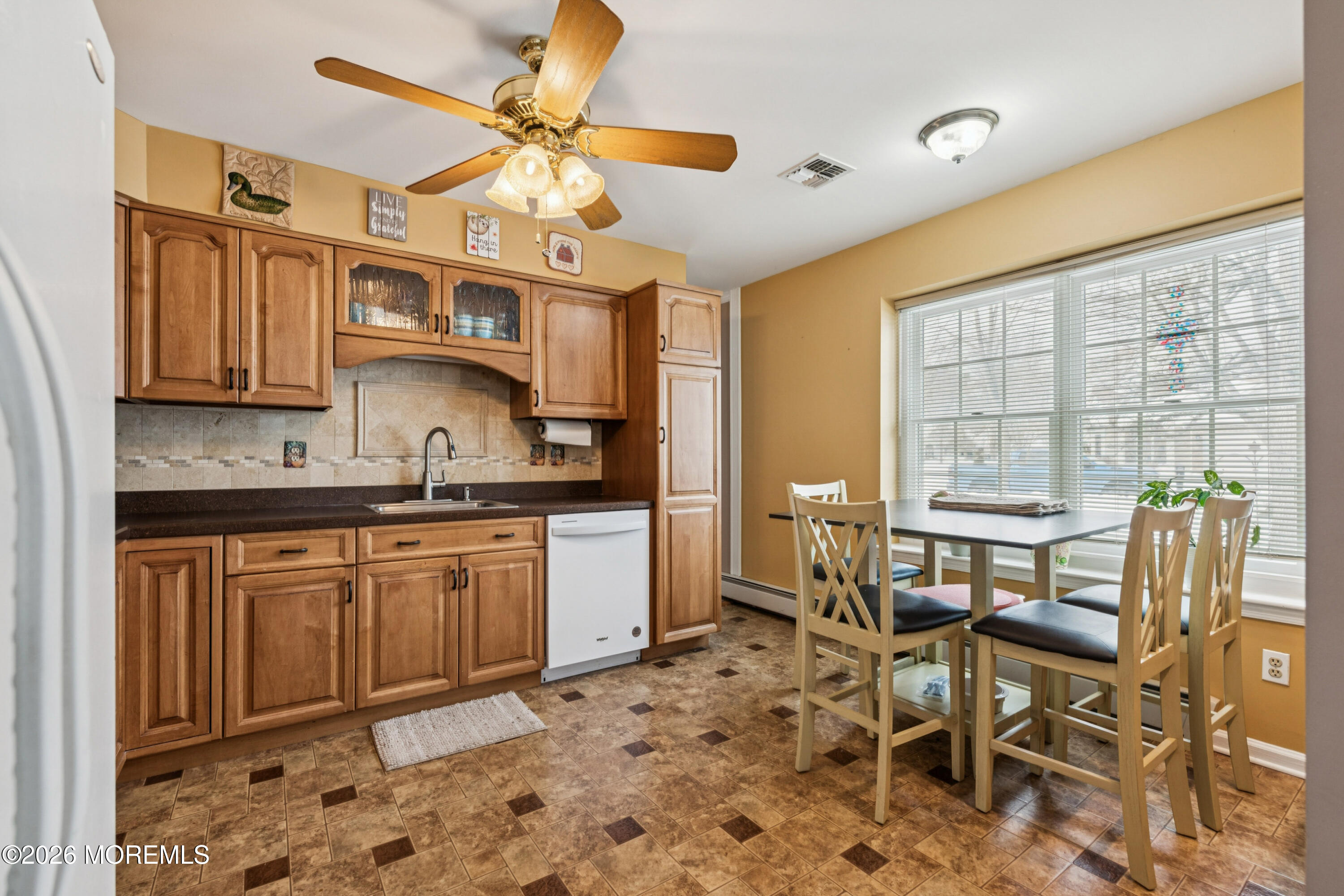 1583 Goldspire Road Toms River, NJ 08755 - Photo 3 of 18 a kitchen with granite countertop a table chairs stove and cabinets