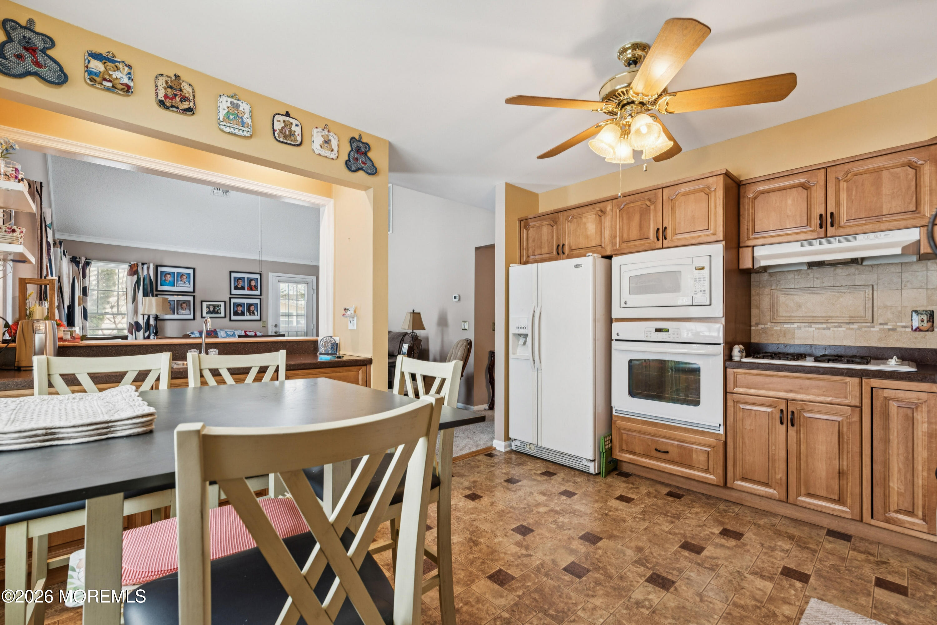 1583 Goldspire Road Toms River, NJ 08755 - Photo 5 of 18 a kitchen with stainless steel appliances granite countertop a dining table chairs stove and refrigerator
