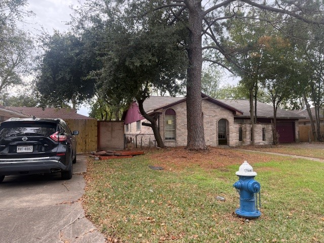338 Coach Lamp Lane Houston, TX 77060 - Photo 3 of 10 a house view with a garden space
