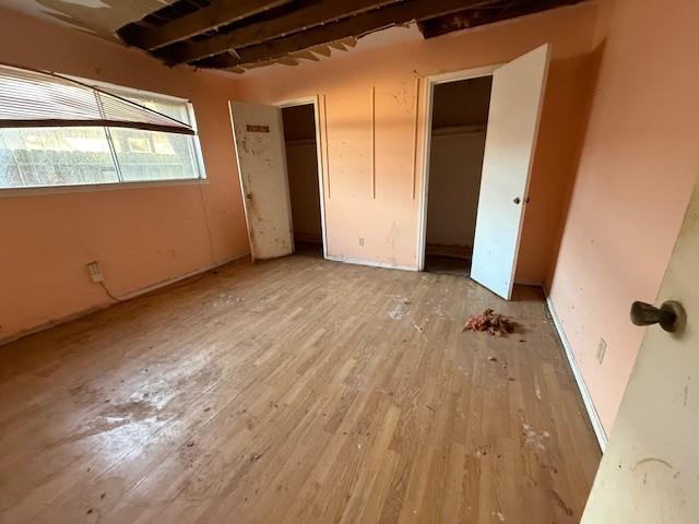 338 Coach Lamp Lane Houston, TX 77060 - Photo 9 of 10 an empty room with wooden floor and windows