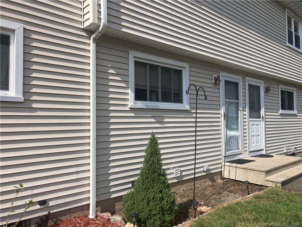 1081 New Haven Road, Unit 1I Naugatuck, CT 06770 - Photo 1 of 1 a view of a house with a yard and a large window
