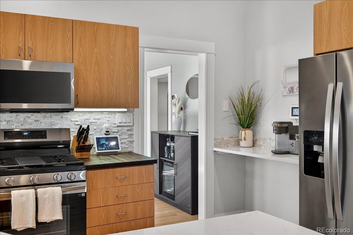 854 South Clarkson Street Denver, CO 80209 - Photo 22 of 50 a kitchen with stainless steel appliances a refrigerator a stove a sink and a counter