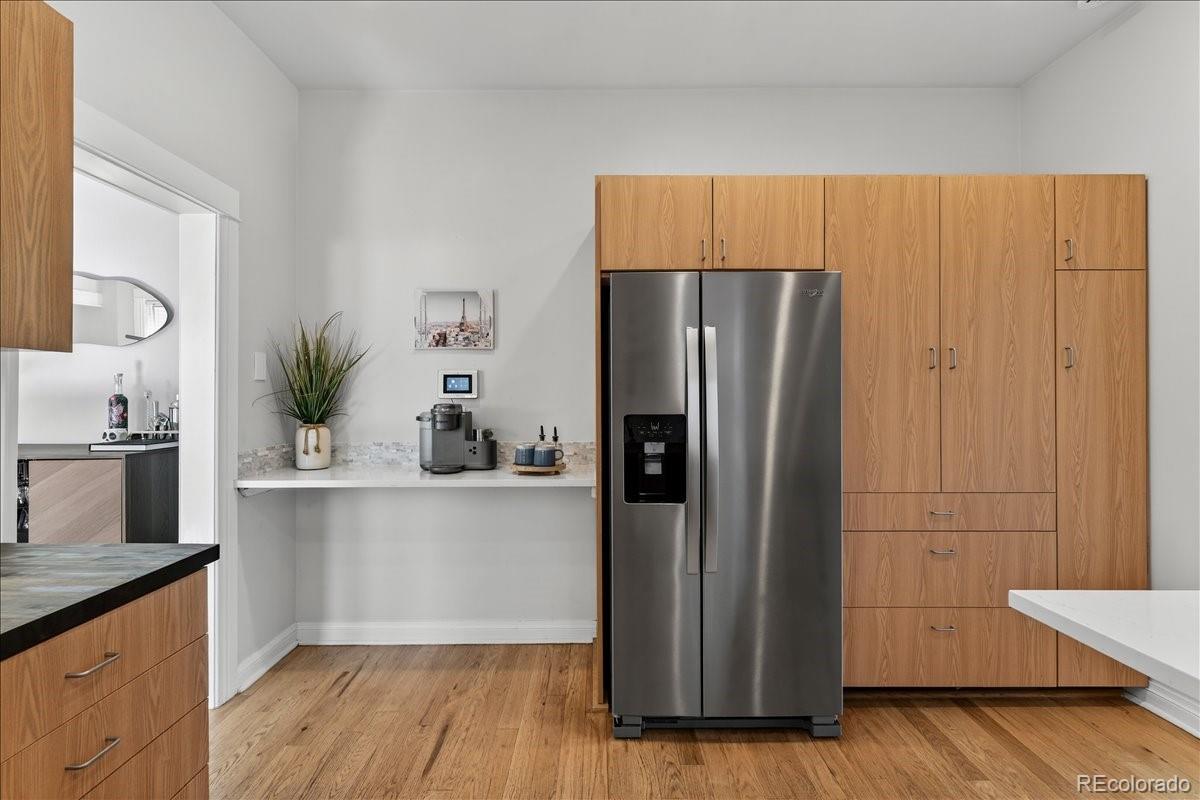 854 South Clarkson Street Denver, CO 80209 - Photo 23 of 50 a kitchen with stainless steel appliances a refrigerator and wooden floor