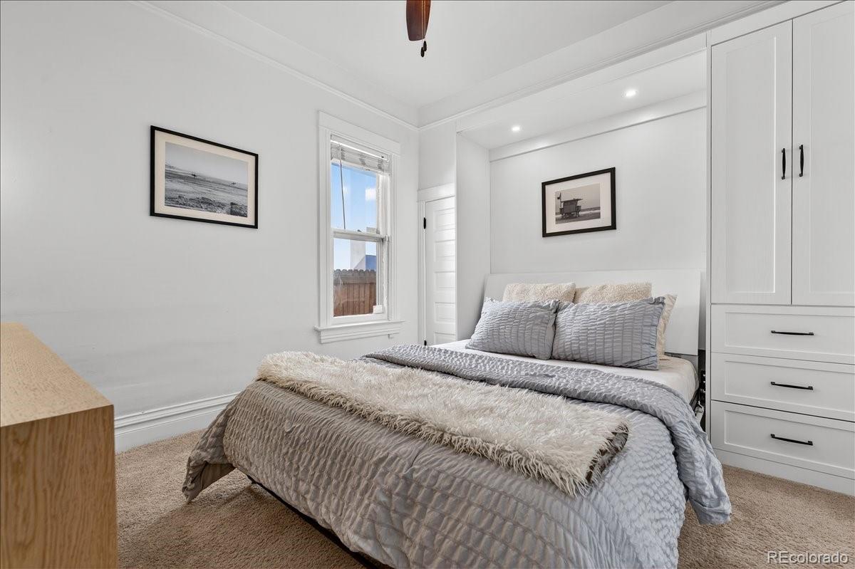 854 South Clarkson Street Denver, CO 80209 - Photo 29 of 50 a bedroom with a bed and a painting on the wall