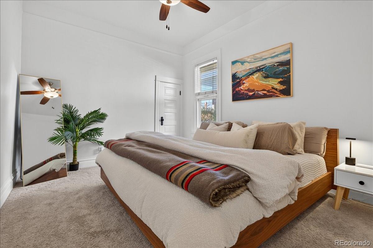 854 South Clarkson Street Denver, CO 80209 - Photo 31 of 50 a living room with couches painting on the wall and a potted plant