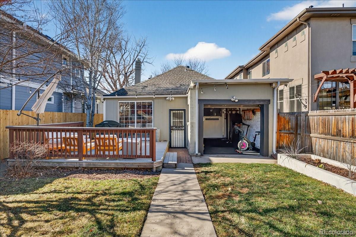 854 South Clarkson Street Denver, CO 80209 - Photo 40 of 50 a view of a house with floor to ceiling windows and a wooden deck