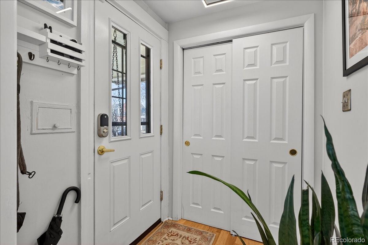 854 South Clarkson Street Denver, CO 80209 - Photo 5 of 50 a view of a hallway with wooden floor and staircase