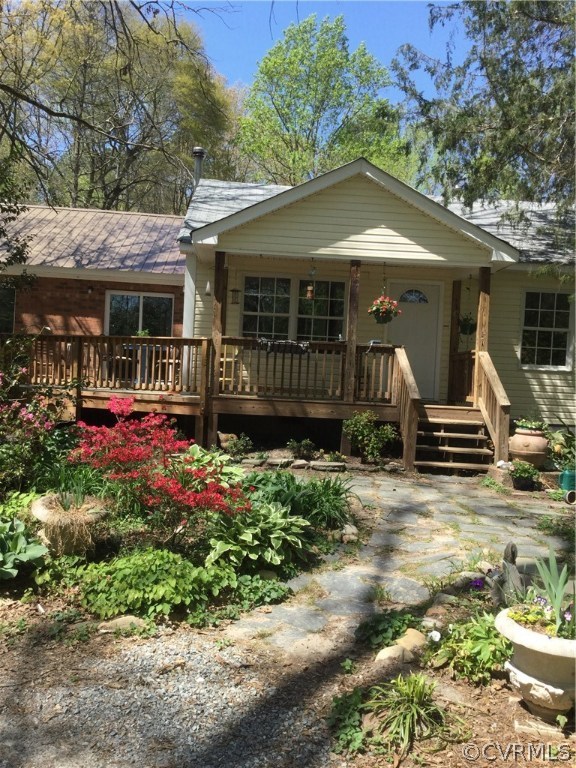 Front porch with beautiful gardens in bloom.