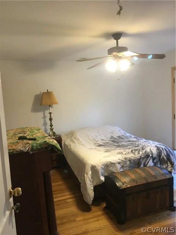Master bedroom with ceiling fan and private deck
