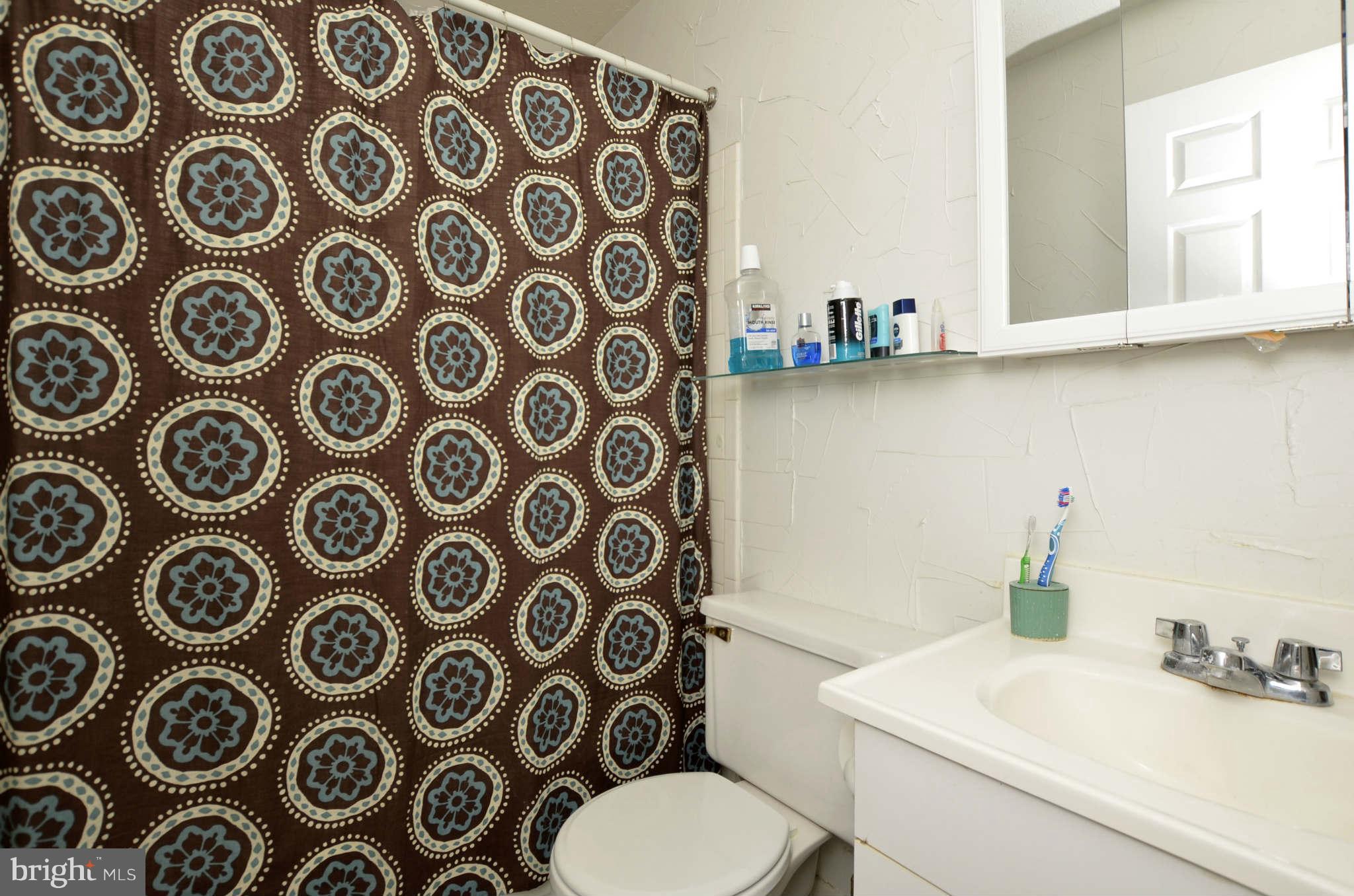 19 Pike Hall Place Baltimore, MD 21236 - Photo 11 of 30 a bathroom with a toilet sink and mirror