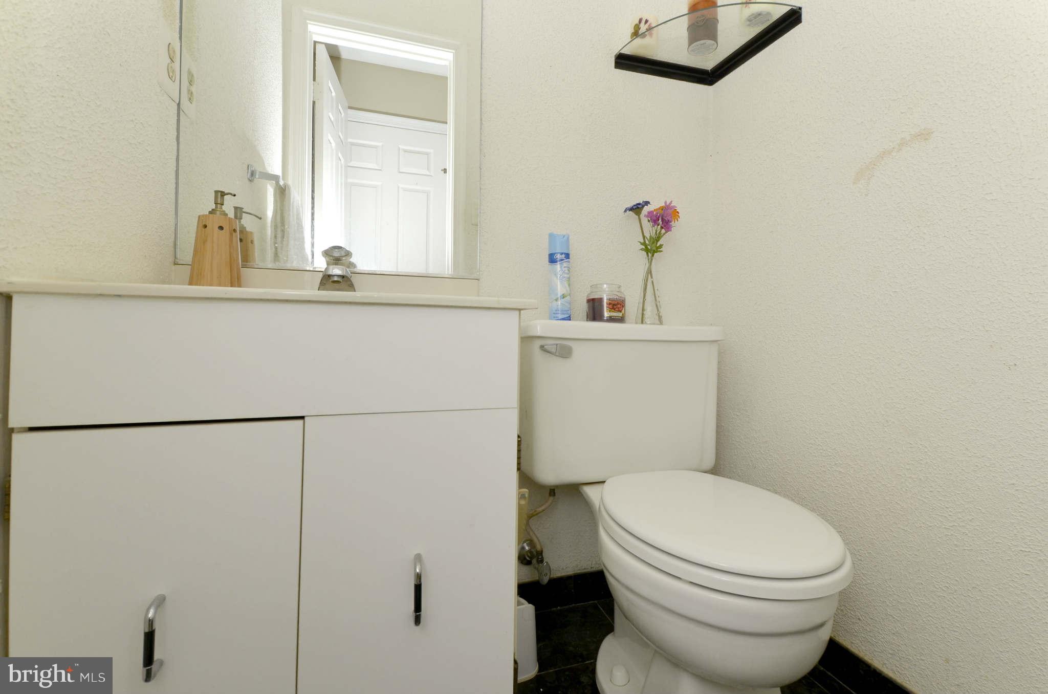 19 Pike Hall Place Baltimore, MD 21236 - Photo 12 of 30 a white toilet sitting next to a bathroom sink