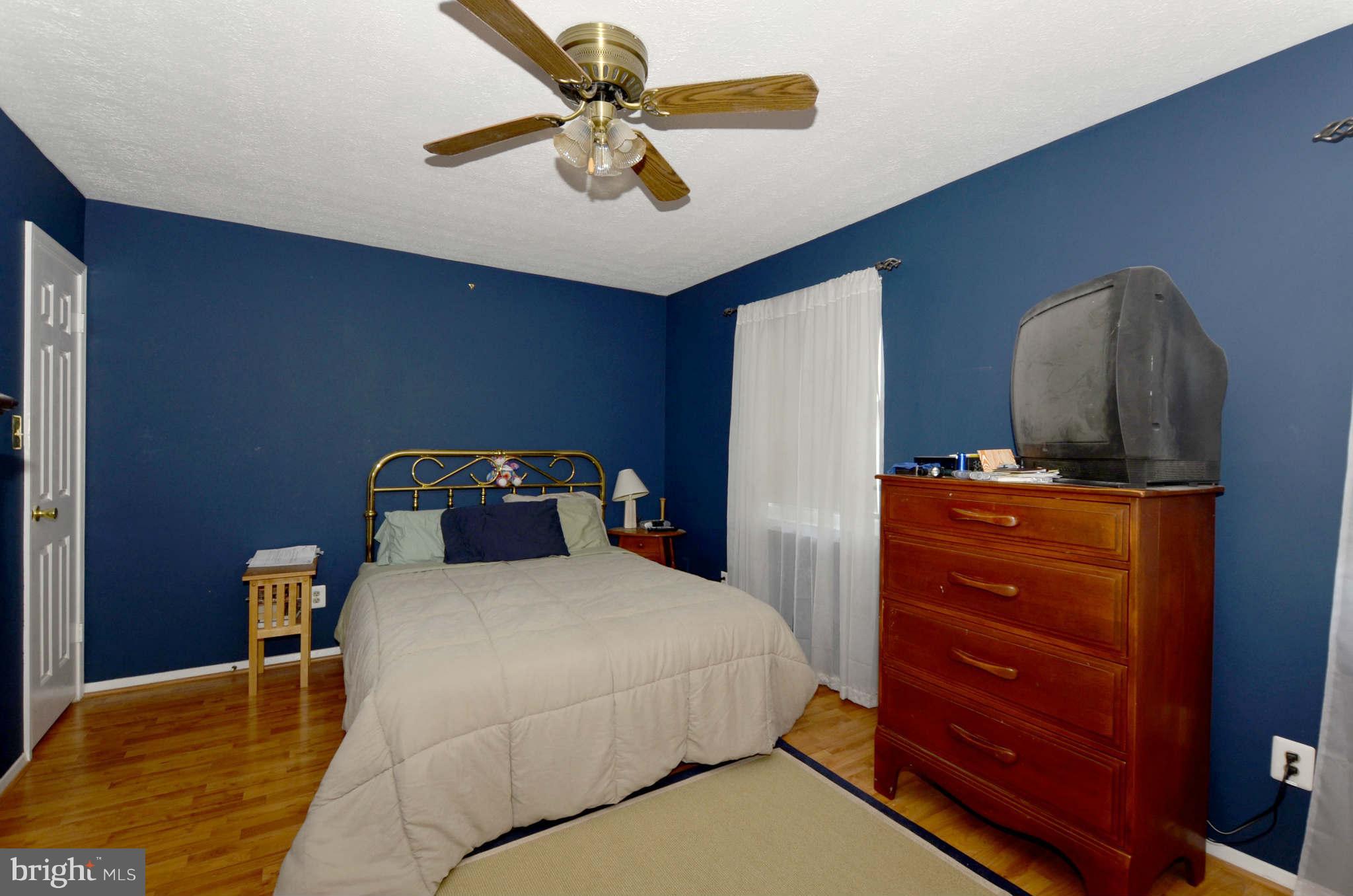 19 Pike Hall Place Baltimore, MD 21236 - Photo 13 of 30 a bedroom with a bed and a dresser
