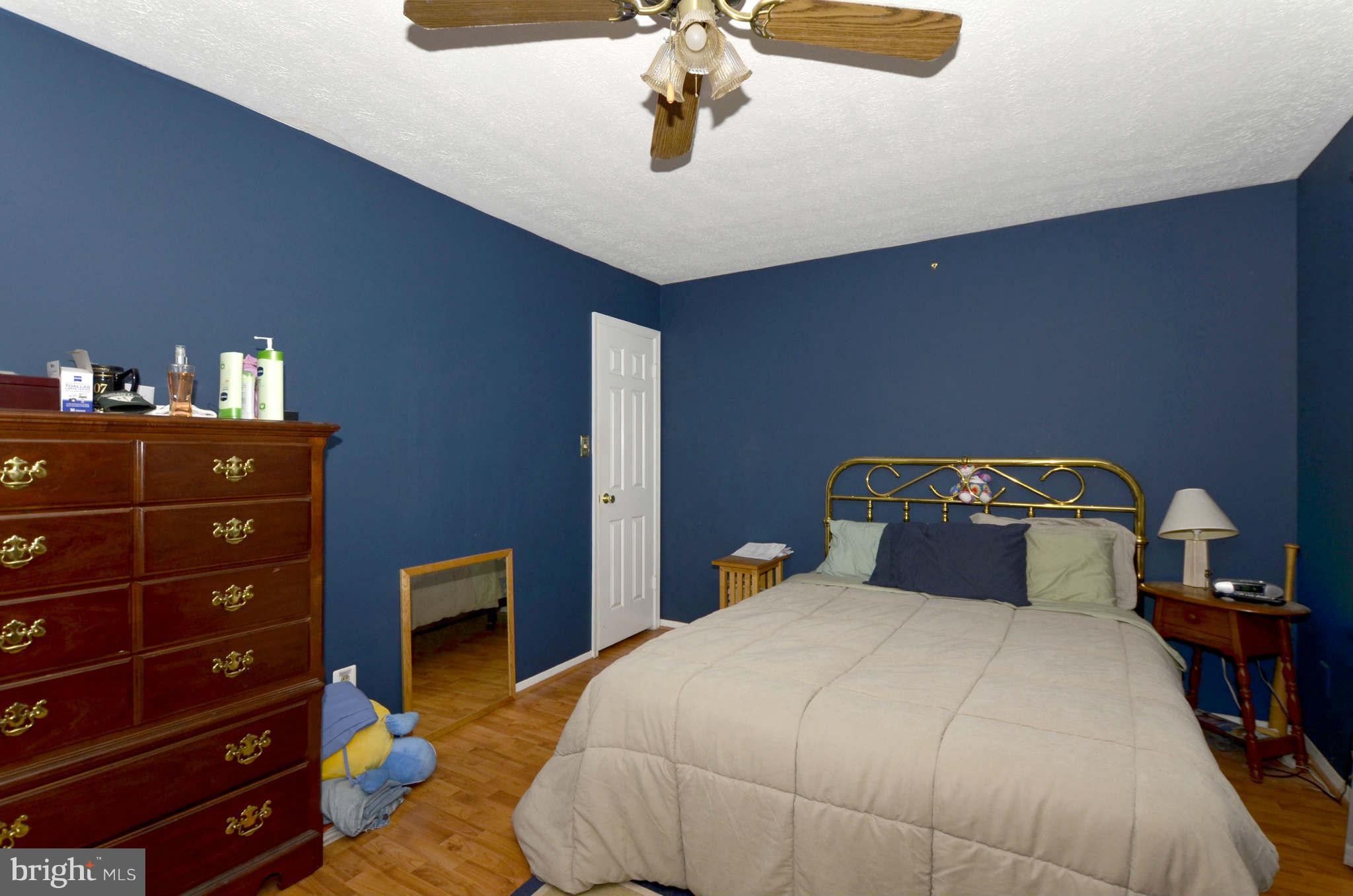 19 Pike Hall Place Baltimore, MD 21236 - Photo 14 of 30 a bedroom with a bed and a table