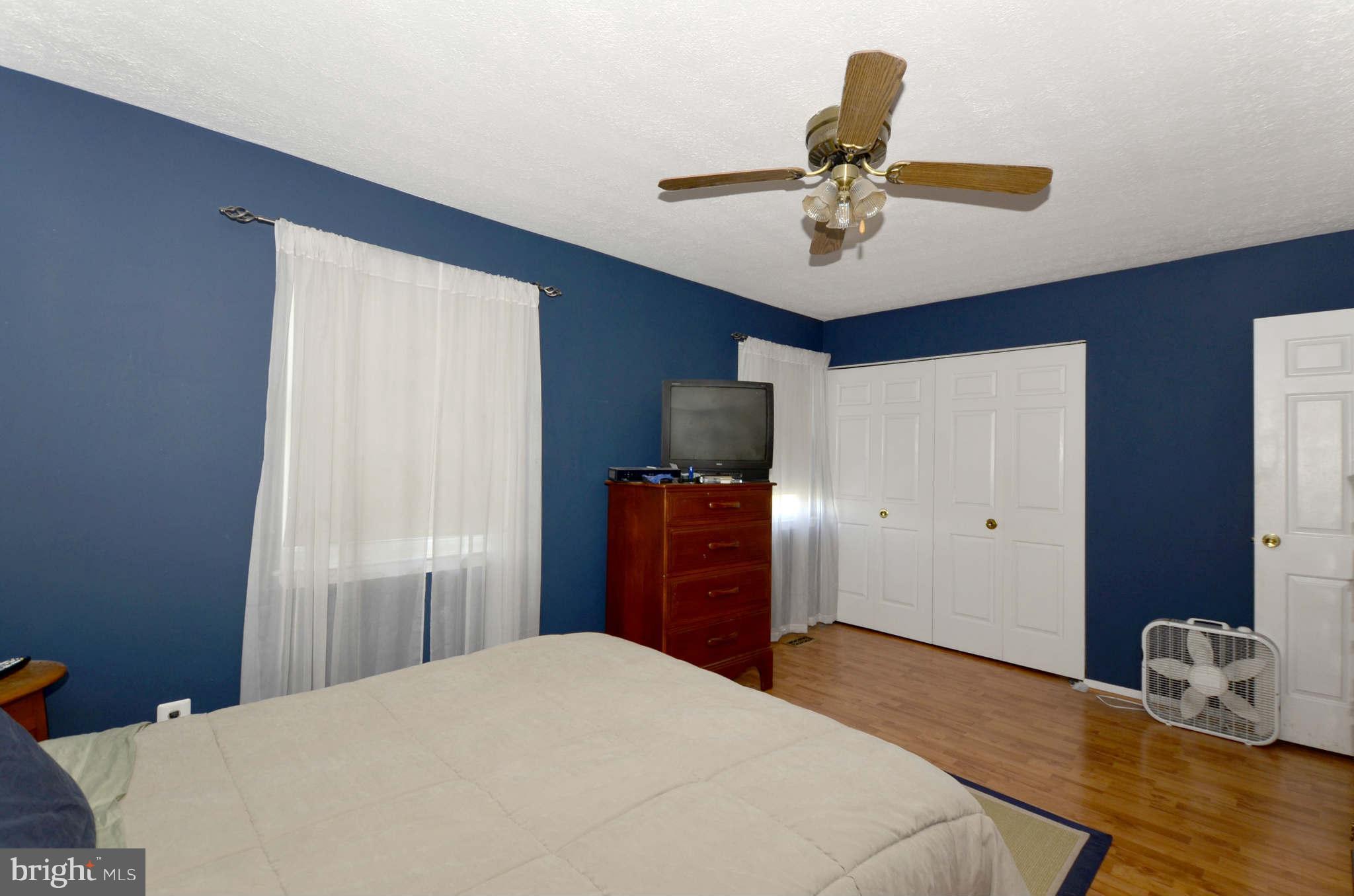 19 Pike Hall Place Baltimore, MD 21236 - Photo 15 of 30 a bedroom with a bed and wooden floor