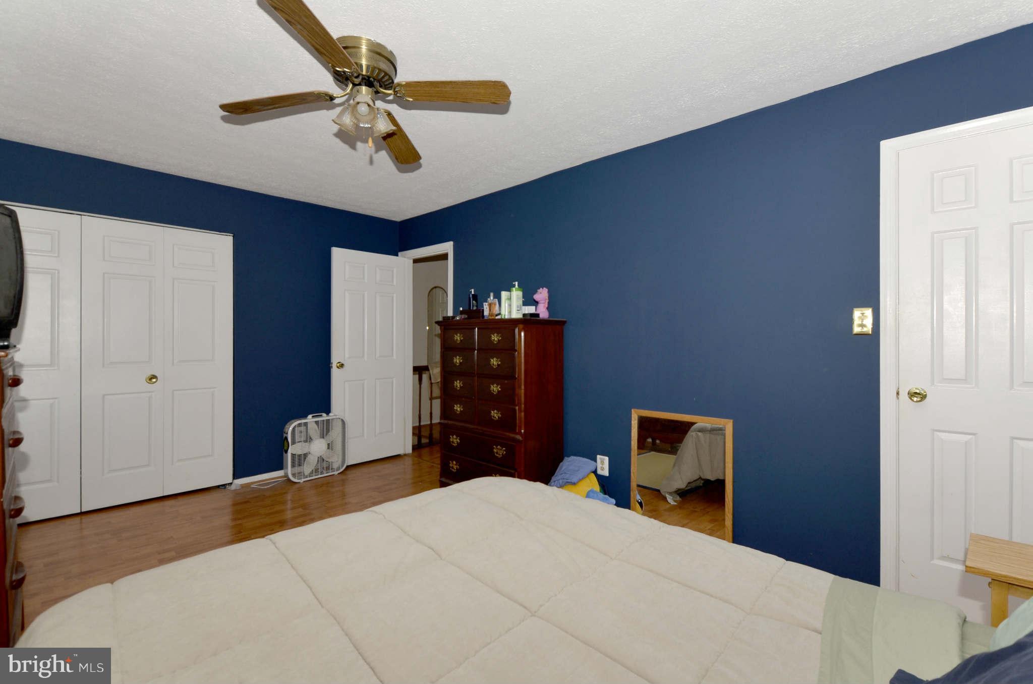 19 Pike Hall Place Baltimore, MD 21236 - Photo 16 of 30 a bedroom with a bed and a chandelier