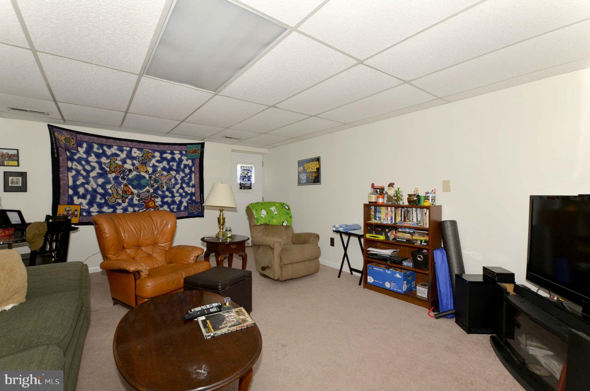 19 Pike Hall Place Baltimore, MD 21236 - Photo 25 of 30 a living room with furniture a flat screen tv and a floor to ceiling window
